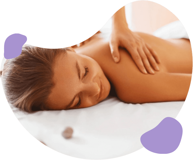 A woman laying on her stomach in the middle of a massage.